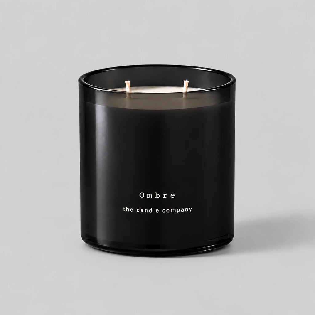 Ombre 400g candle in black smoked glass with two cotton wicks on a neutral grey background