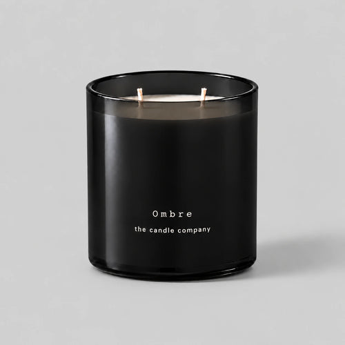 Ombre 400g candle in black smoked glass with two cotton wicks on a neutral grey background