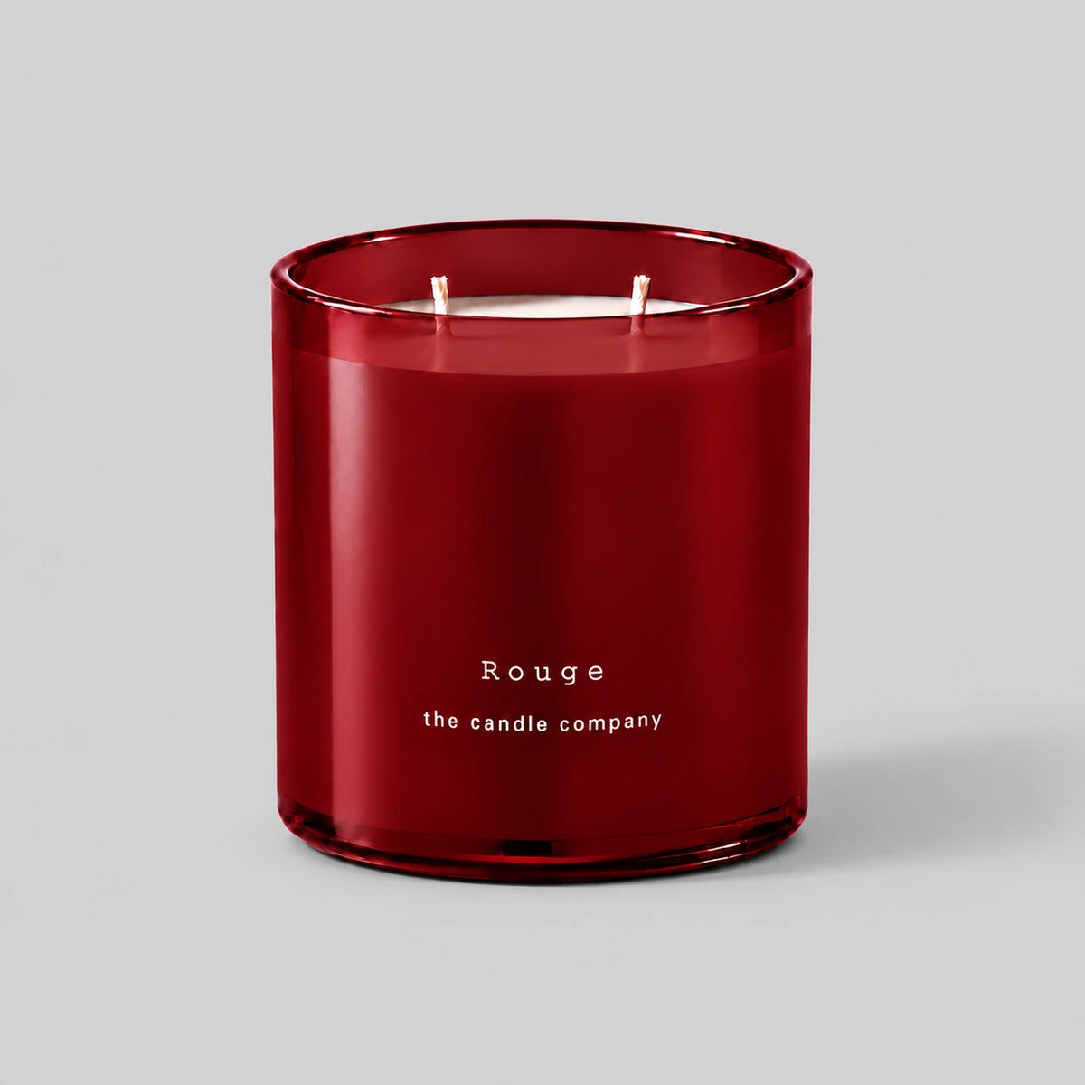 Rouge 400g candle with two cotton wicks on a neutral grey background